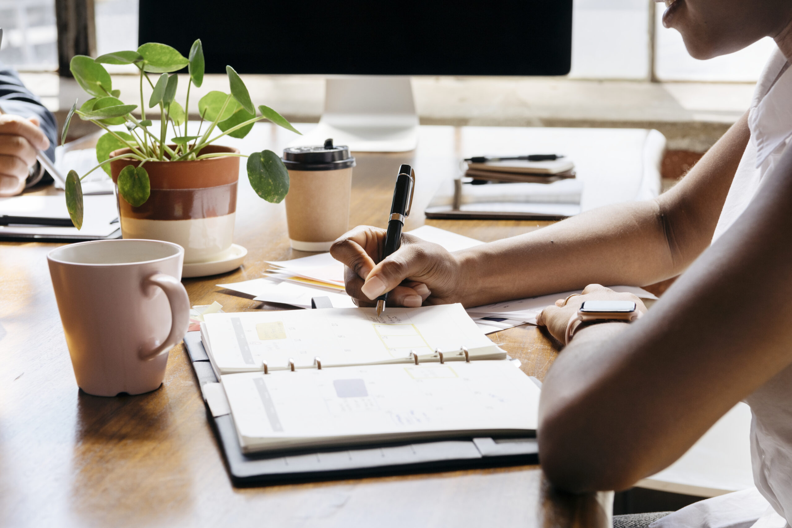 Businesswoman writing on personal organizer schedule